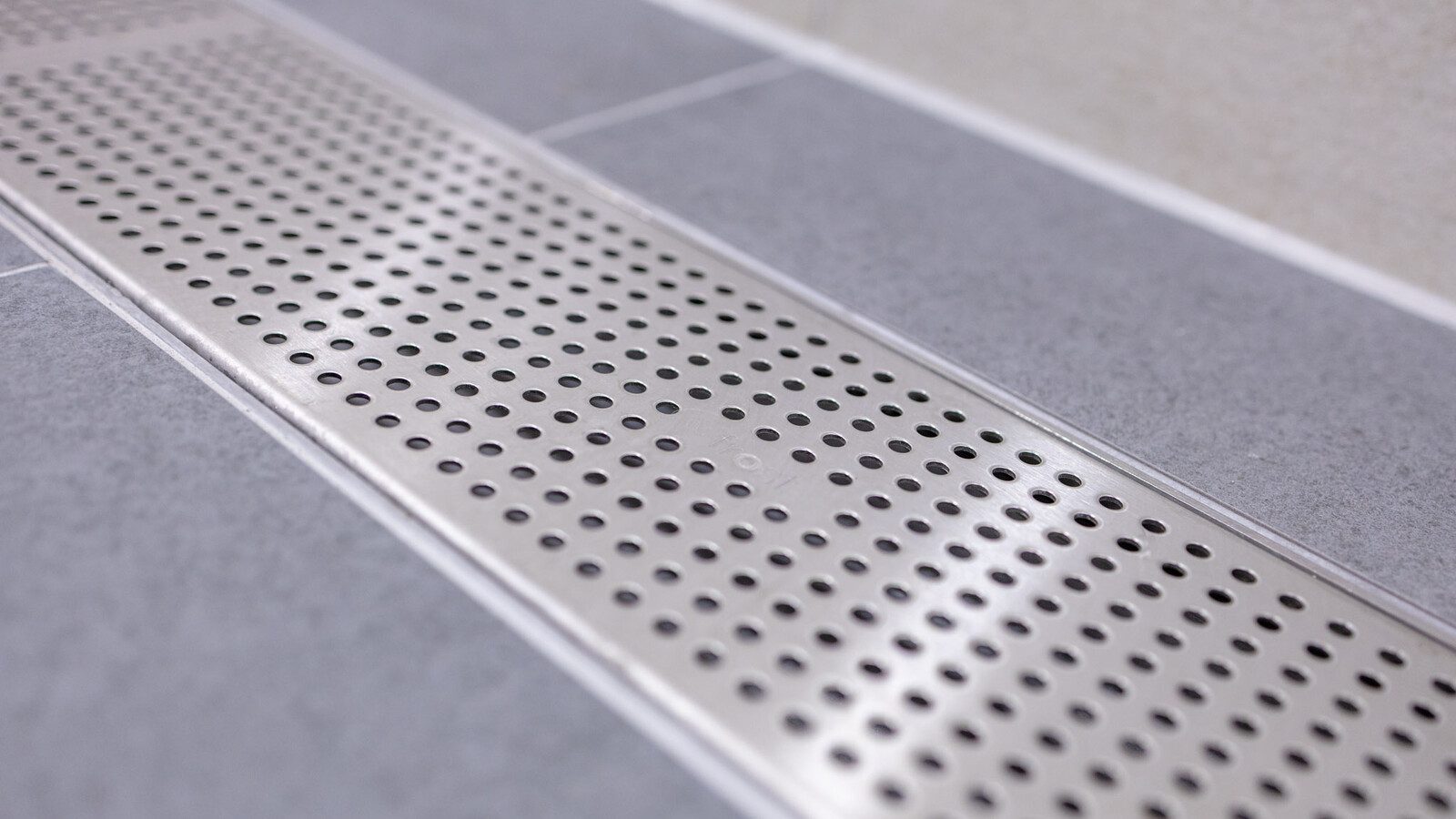 Refined shower rooms at Wembley Stadium with frost linear drainage installations.