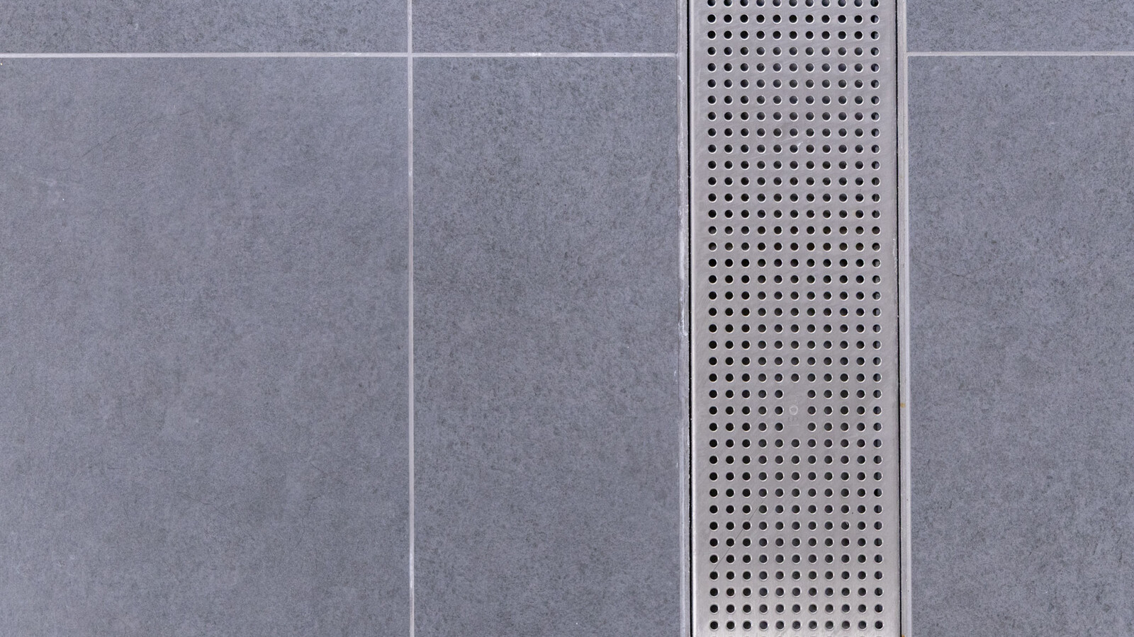 Renovated shower facilities at Wembley Stadium with advanced frost linear drainage systems.