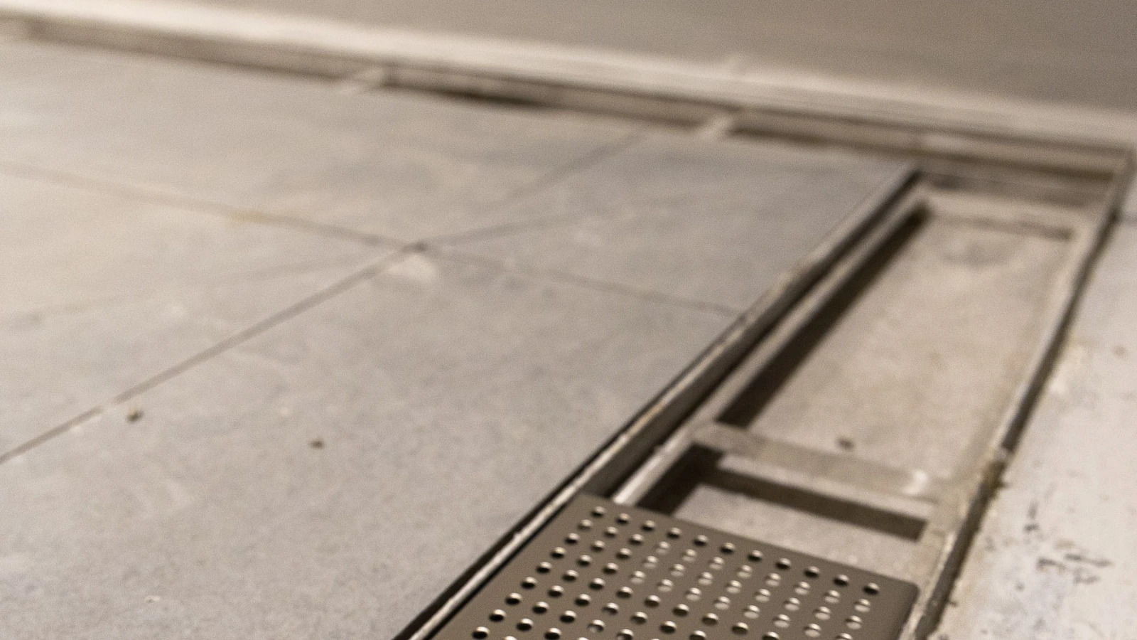 Detail shot of Frost linear drainage integrated into the flooring at Wembley Stadium.