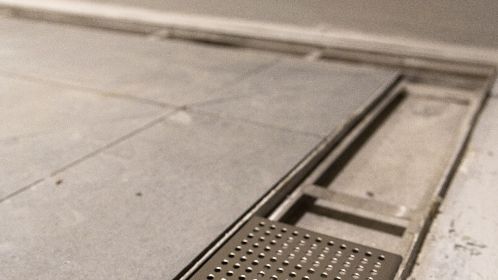 Detail shot of Frost linear drainage integrated into the flooring at Wembley Stadium.